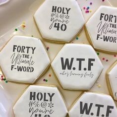 decorated cookies on a plate with words written in black and white icing to spell out the names of different people