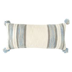 a blue and white striped pillow with tassels on the front, sitting against a white background