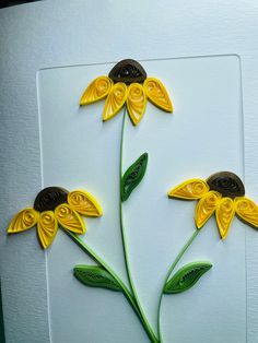 some yellow flowers are on a white board