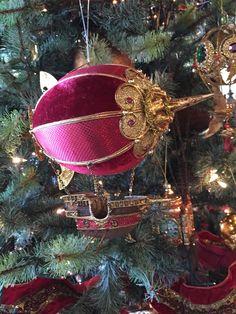 an ornament hanging from the top of a christmas tree