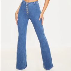 These Jeans Are Sure To Give Your Look A Vintage Vibe. Featuring A Mid Wash Denim Material With A High Waisted Fit, Button-Down Design And Flared Leg, Team With A Crop Top And Heeled Boots For A Look We Are Loving. Length Approx 86.5cm/34" (Based On A Sample Size Uk 8) Model Wears Size Uk 8/ Eu 36/ Aus 8/ Us 4 Model Height - 5ft 9" Trendy Non-stretch Button-up Jeans, Blue Mid-rise Flare Jeans With Button Closure, Blue Button-up Summer Pants, Blue Stretch Bottoms With Button Zip Fly, Stretch Blue Bottoms With Button Zip Fly, Blue Stretch Bottoms With Button Closure, Blue Wide Leg Flare Jeans With Button Closure, Stretch Blue Bottoms With Button Closure, Fitted Denim Blue Pants With Button Closure