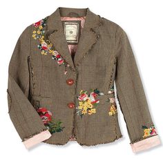 a brown jacket with flowers on the side and pink trimmings, sitting on top of a white surface