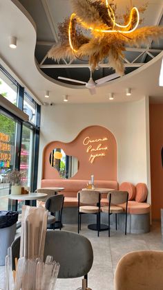 the inside of a restaurant with chairs, tables and chandelier hanging from the ceiling