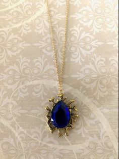 "Large antique gold and royal blue teardrop stone necklace, royal stone pendant, large blue necklace, royal necklace, royal blue necklace, necklace royal, royal blue pendant.  Pendant measures 1 1/2\" L X 1 1/8\" W and is on an 18\" chain.   ★ Want to see more?  Please visit my shop at: https://www.etsy.com/shop/DesignsByPeg" Royal Blue Pendant Jewelry As Gift, Royal Blue Necklace, Royal Blue Jewelry Necklaces, Royal Blue And Gold Necklace, Luxury Blue Victorian Necklaces, Elegant Royal Blue Gemstone Necklace, Blue Stone Necklace, Blue Sapphire Necklace, Royal Blue And Gold