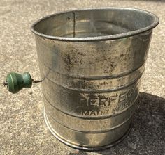 an old metal bucket sitting on the ground