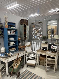 a room filled with lots of different types of furniture and decor on display in front of mirrors