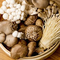 a basket filled with lots of different types of mushrooms