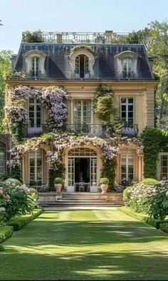 a large house with lots of flowers on it