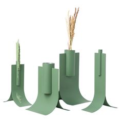 three tall green vases with plants in them