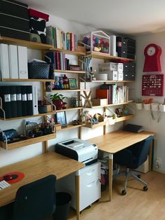 a home office with desk, shelves and printer