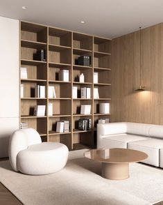 a living room filled with white furniture and bookshelves