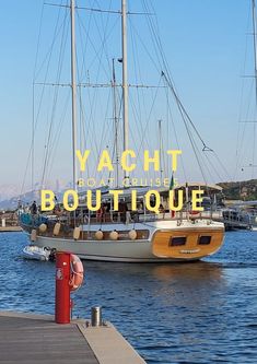 there is a boat that is in the water and it says yach bouttiquee