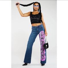 a woman with braids holding a skateboard in one hand and wearing sunglasses on the other