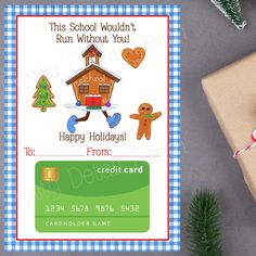 a school holiday gift card with gingerbreads and a house on it next to a christmas tree