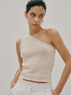 This is ODER’s unique sleeveless knit top, designed to make a statement. With its stretchy fabric, it offers comfortable wear, making it suitable for both layering with innerwear or wearing on its own. This versatile piece is a wardrobe essential that effortlessly complements any outfit.- Perfect for daily wear, providing both comfort and style- Ideal for pairing with different styles of bottoms- Its clean style effortlessly complements any look Beige Seamless Crop Top, Versatile Fitted Beige Tank Top, Beige Fitted Sleeveless Top, Fitted Beige Tank Top For Summer, Stretch Beige Tank Crop Top, Beige Fitted Tank Top For Summer, Beige Stretch Crop Tank Top, Chic Beige Sleeveless Crop Top, Fitted Beige Knit Tank Top