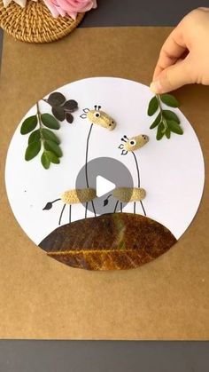 someone is making a paper cut out of leaves