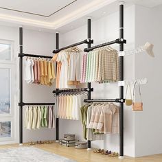 an open closet with clothes and shoes hanging on the wall next to a large window