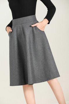 "This winter wool skirt is a classic piece of tailoring that will see you through rain or shine. It is cut with a flattering flared skirt to give you a wonderful shape. The winter skirt is perfect classic styling and ends at the ankle. This is a versatile skirt that you'll wear again and again. DETAILS: * 30% wool, 30% fiber, 40% polyester * fully satiny liner * Two side pockets * Right zip closure * A litter Back elastic, comfortable wear * Plus size skirt * Above knee length * Perfect for Wint Winter Full Skirt Bottoms With Pockets, Winter Flared Skirt With Pockets, Elegant Fall Skirt With Pockets, Gray Lined Skirt For Work, Fall Midi Skirt With Side Pockets, Gray Workwear Skirt With Pockets, Solid Color Skirt For Winter Workwear, Winter A-line Bottoms With Pockets, Solid Color Winter Workwear Skirt