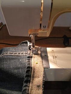 the jeans are being sewn together with a sewing machine