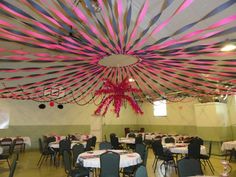 the ceiling is decorated with pink and blue ribbons