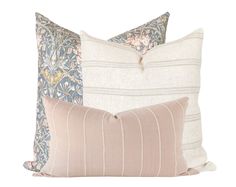 three pillows with different patterns on them, one in blue and the other in pink