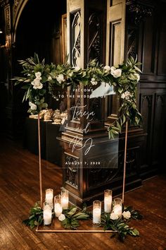 candles and greenery are arranged in front of an altar with the words, love is written on it