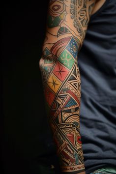 a man's arm with tattoos on it