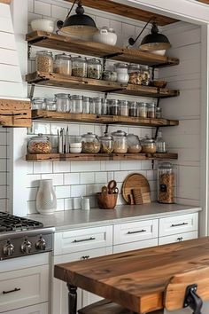 a kitchen filled with lots of open shelves and wooden counter top next to an oven