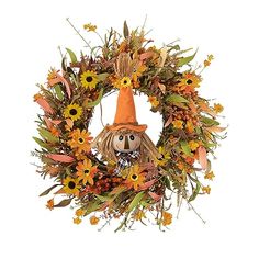 a wreath with a scarecrow and sunflowers on it