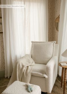 a white chair and ottoman in a room