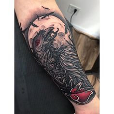 a man's arm with a black and grey tattoo design on the left forearm