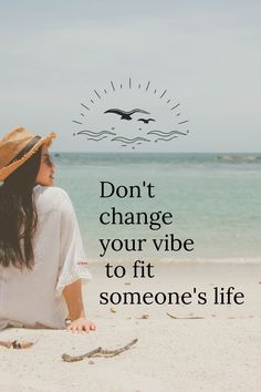 a woman sitting on top of a sandy beach next to the ocean with a quote above her