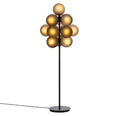 a floor lamp with five balls on it