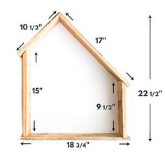 a wooden house frame with measurements for the top and bottom half, on a white background