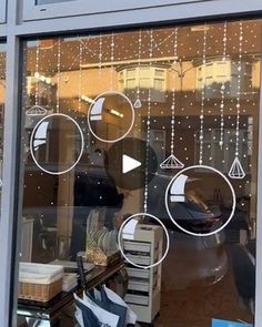 a store front with many different items in the window and decorations hanging from the windows