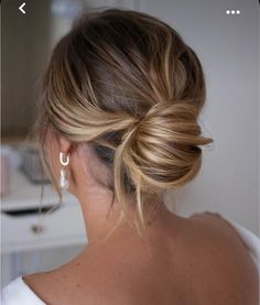 a woman with blonde hair in a low bun