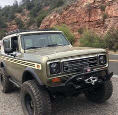 an off - road vehicle is parked on the side of the road