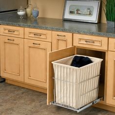 a kitchen cabinet with a basket in it