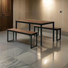 two wooden benches sitting next to each other on top of a tile floor in front of a door