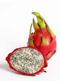 a dragon fruit cut in half on a white background