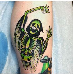 a person with a green and black tattoo on their leg, holding a bird in the air