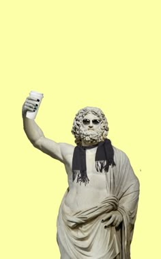 a white statue with a black scarf around it's neck and hands in the air