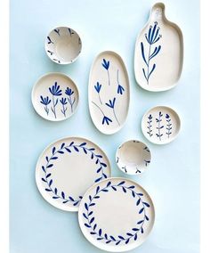 blue and white plates with designs on them are arranged in the shape of oval bowls