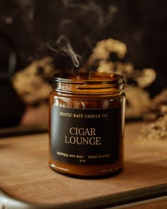 Cigar Lounge embodies the essence of an old fashioned smoking room with worn leather chairs and smoldering cigars. This fragrance curates a sophisticated ambiance with notes of cedarwood, leather, and musk, along with the distinctive scent of smoked tobacco.CIGAR LOUNGE FRAGRANCE NOTESTobacco / Leather / Cedarwood / Smoke / Clove / MuskMADE WITH SIMPLE INGREDIENTS 100% pure soy wax, phthalate free premium fragrance oils, and a lead and zinc free cotton wick. The fragrances we use are phthalate f Four Gables, Good Cigars, Office Decorating, Amber Jars, Leather Chairs, Candle Jar, Tin Candles, Clean Ingredients, Fragrance Oils