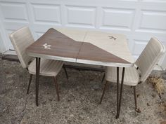 a table and four chairs sitting in front of a garage door with a star on it