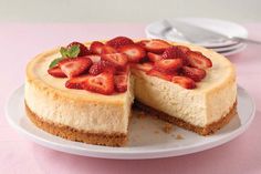 a cheesecake topped with strawberries on a white plate