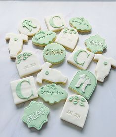 cookies decorated with green and white icing on a table top, including ones that say ciara