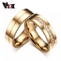 two gold wedding rings with white diamonds on each one and the word vox written in red