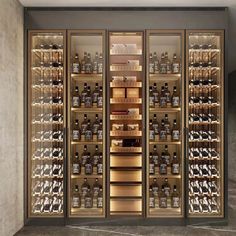 the wine cellar is full of many bottles and glasses in it's glass doors