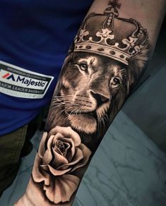 a lion with a crown on his head and a rose